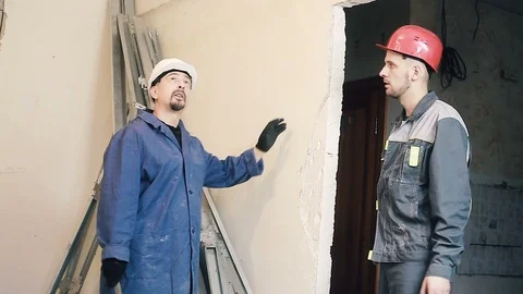 Builder and Manager checking colleagues work Stock Footage 99782621