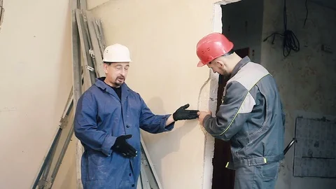 Builder and Manager checking colleagues work Stock Footage 99783916