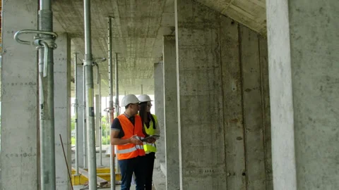 Builder and manager walks through scaffolding poles Stock Footage 317618346