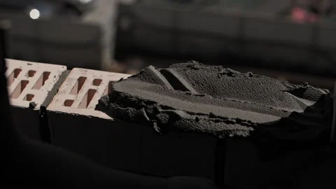 Builder applies concrete to the bricks. Close-up of the worker hands. Stock Footage 245309886