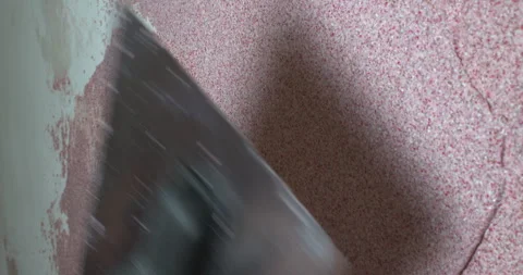 The builder applies decorative plaster with a spatula Stock Footage 305652198
