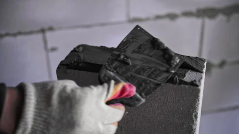 Builder applies the mortar to the brick Stock Footage 241712867