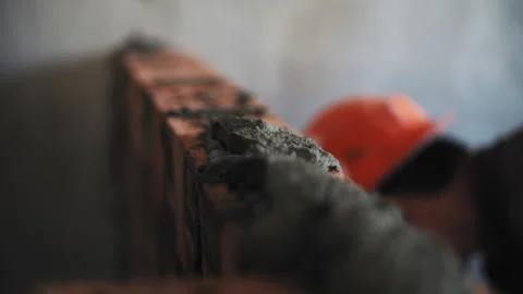 Builder applying mortar to brick wall Stock Footage 276668437