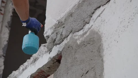 Builder applying mortar with trowel at house construction site Video stock 244476895