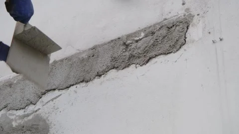 Builder applying mortar with trowel at house construction site Stock Footage 244477175