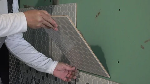 Builder applying tile on wall Stock Footage 125844545