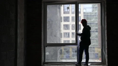 Builder assembles window in new building Stock Footage 231797983