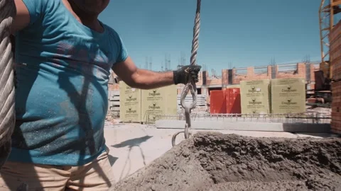 Builder attached hook to a concrete container and raised it with crane Video stock 143217364