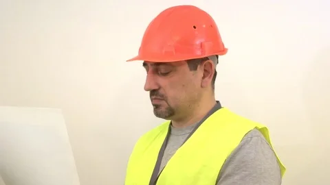 Builder with a beard reading a drawing Stock Footage 93098572