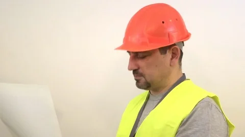 Builder with a beard reading a drawing Stock Footage 93098751