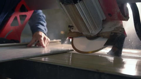 Builder bevelling the edge of a large wall tile Video stock 142105754