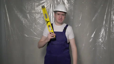 Builder in blue overalls and white hard hat helmet and protective glasses. Vidéo 170335345