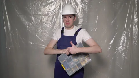 Builder in blue overalls and white hard hat helmet and glasses with toolbox. Vidéo 235620216