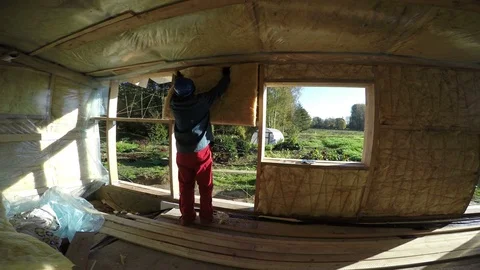 Builder with blue safety hat insulating house, 4K 스톡 동영상 72138876