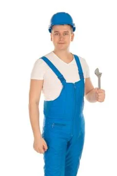 Builder in blue uniform with tools in hand Stock Photos