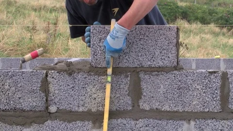 Builder building blocks for a house Stock Footage 78060433