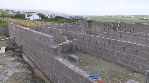 Builder building blocks for a house Stock Footage 78060546