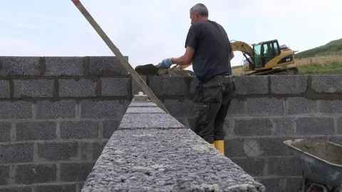 Builder building blocks for a house Stock Footage 78060771