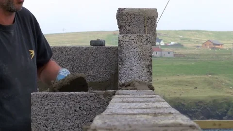 Builder building blocks for a house Stock Footage 78060925