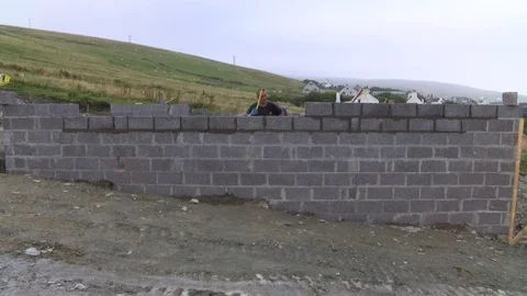 Builder building blocks for a house Stock Footage 78060961