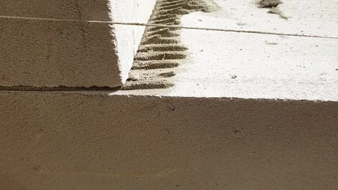 The builder is building a house of blocks. Building construction. Stock Footage 115643549