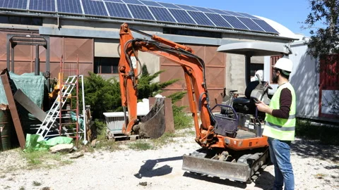 Builder at building site wearing work helmet use the tablet. Stock Footage 153077641