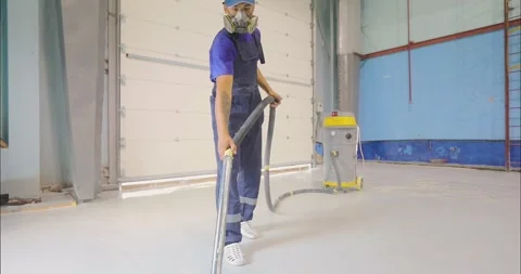 A builder cleans the construction site of dust using a construction vacuum Stock Footage 263435961