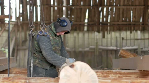 Builder connects logs the future of the wooden house with the help of an Stock Footage 69069924