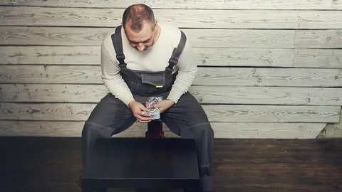 The Builder considers the earned money Stock Footage 105720929