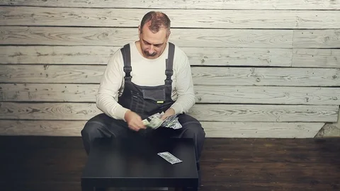 The Builder considers the earned money Stock Footage 105722679