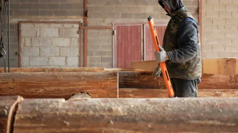 Builder construction check bubble level wooden logs future home. Pencil in the Video stock 69060785
