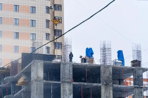 Builder on the construction site of a house under construction Stock Photos