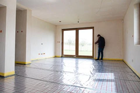 Builder on construction site with measure Stock Photos