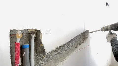 The builder on the construction site works with a hammer drill Video stock 155358850