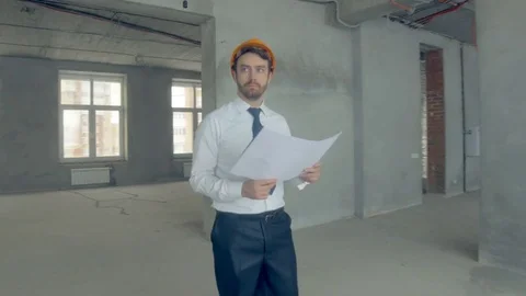 Builder, construstor examines new building. Businessman in suit inspecting Video stock 70105915