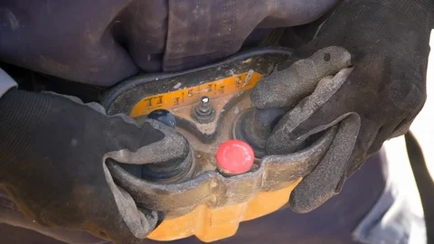 The Builder controls the crane with a remote control Video stock 121728568