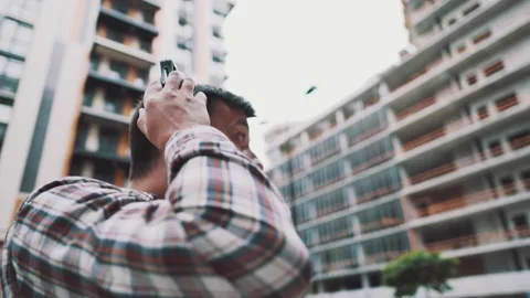 Builder covers his ears, ear muff to protect workers ears. Construction worker Stock Footage 139989198