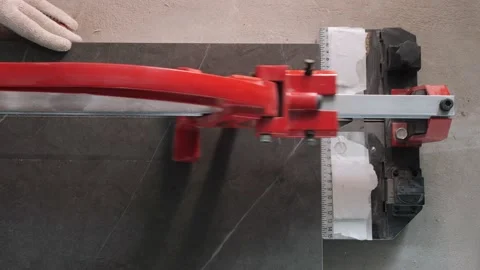 Builder cuts black ceramic panel with tile cutter machine Stock Footage 151784167