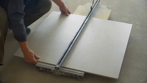 Builder cuts ceramic tile close up Stock Footage 121728038