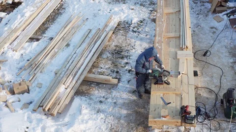 Builder cuts plank with circular saw and carries it away. Frame house building Vídeos de archivo 123736993