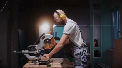 A builder cuts a wooden board on a table circular saw in construction studio 스톡 동영상 170502658