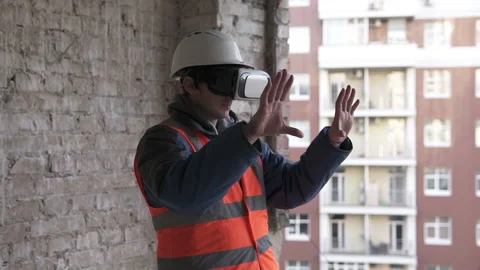 Builder designer designs a room in 3D virtual reality VR glasses. Stock Footage 147913671