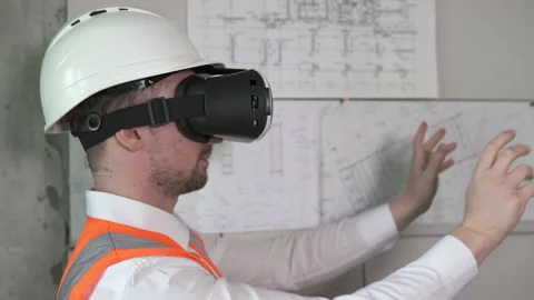 Builder designer designs a room in 3D virtual reality VR glasses. Stock Footage 156858065