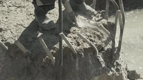 Builder destroys foundation with impact hammer Stock Footage 285143692
