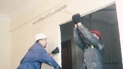 The Builder destroys the plaster on the wall Stock Footage 99790205