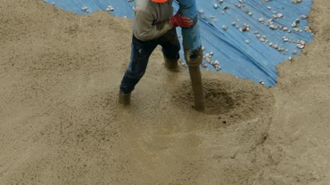 Builder directs pipe with pouring concrete Stock Footage 116619442