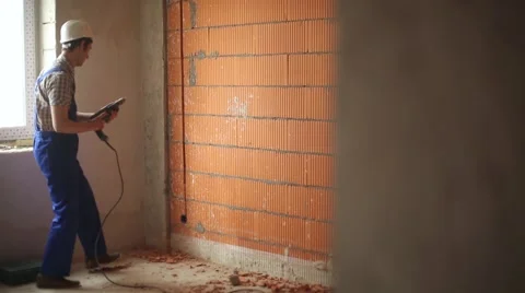 Builder with a drill Stock Footage 61695097