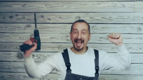 Builder with a drill rejoices earned money 動画素材 83236339