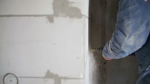 The builder is drilling the wall Stock Footage 142285604