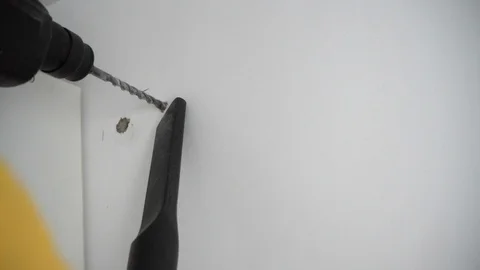A Builder drills a hole in the wall 스톡 동영상 103948229